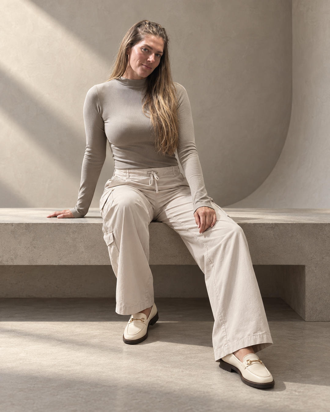 Kinetic Seamless Long Sleeve Top in Satellite shown seated with corset-inspired rib detailing